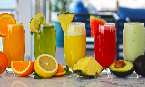 Fruits and fruit juices are kept on table.