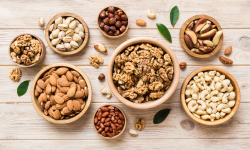 Variety of nuts are kept in different bowls.